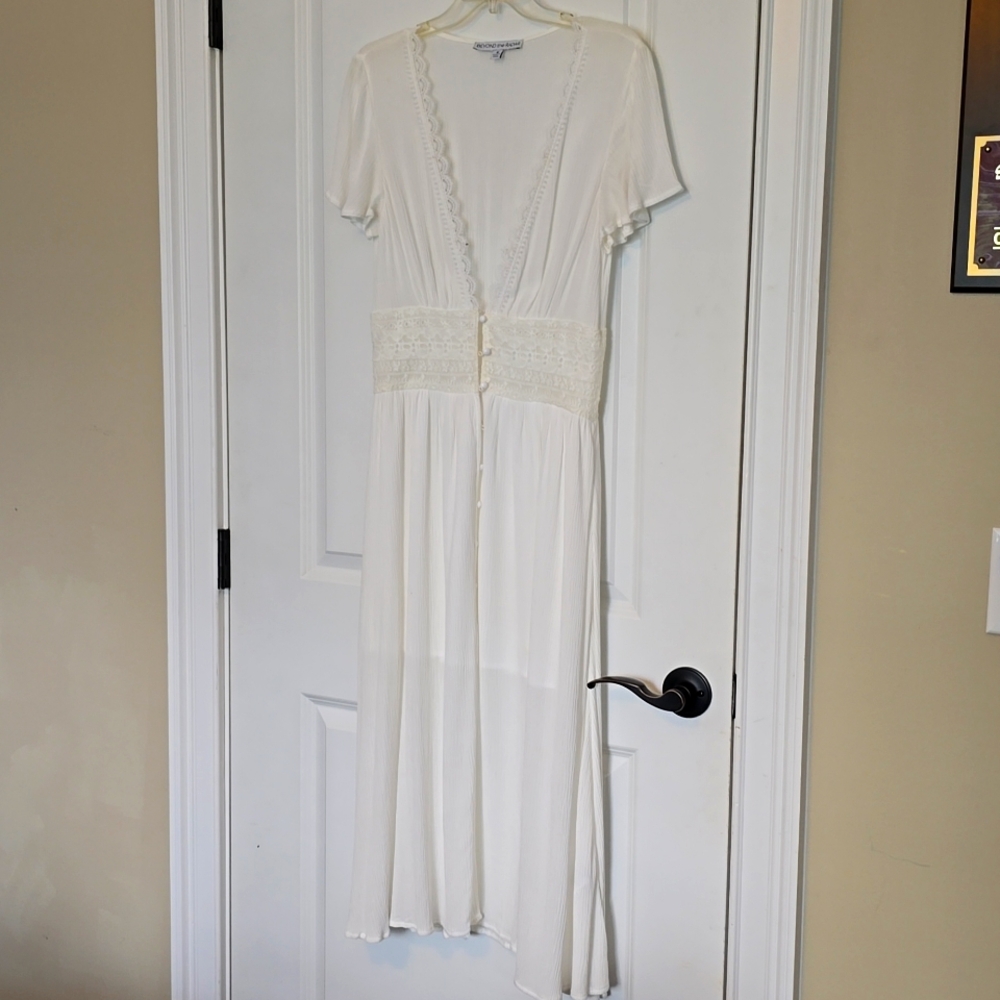 Beautiful dress never worn has a panel underneath.That goes to the knee